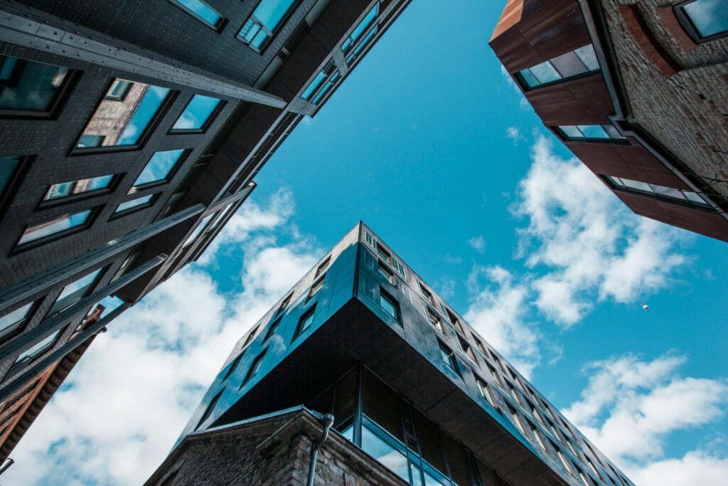 Low Angle Photo of Skyscrapers Under White Cloudy Sky