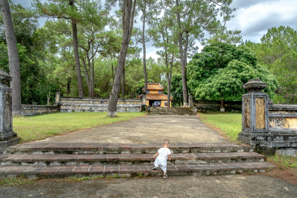 Child Exploring Ancient Temple in Lush Forest