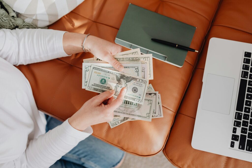 Woman Counting Dollar Bills