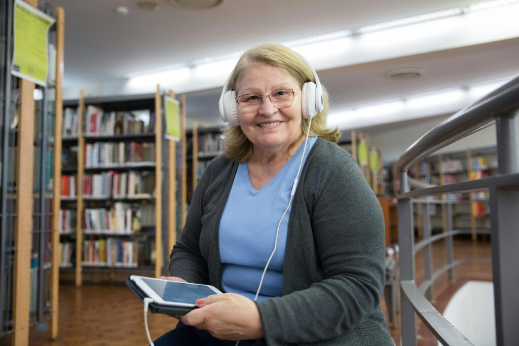 Woman in Gray Cardigan Holding White Ipad