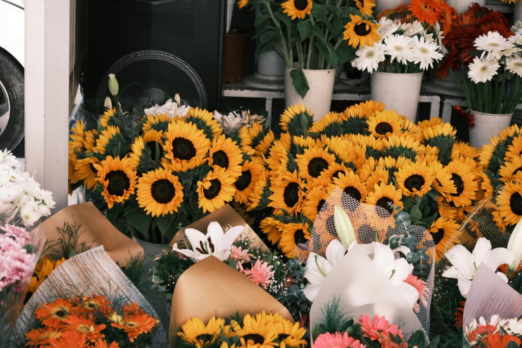 Vibrant sunflowers and mixed bouquets at a flower shop in İzmir, Türkiye.